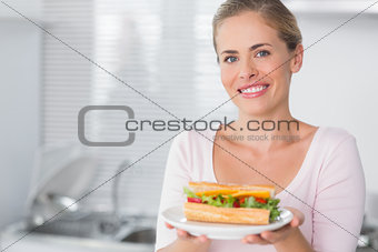 Happy woman holding sandwich