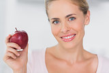Woman holding apple in right hand