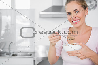 Cheerful woman holding bowl of cereal