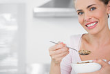 Happy woman holding bowl of cereal