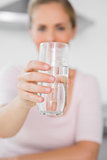 Blonde woman offering water