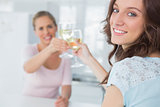 Cheerful women holding glasses of white wine