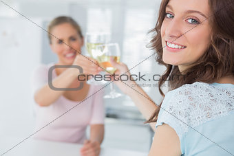 Cheerful women holding glasses of white wine