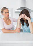 Worried woman comforting her upset friend
