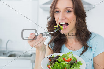 Brunette eating healthy salad