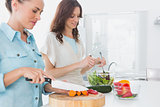 Women preparing salad together