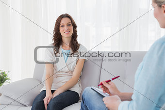 Brunette sitting on the couch at therapy session