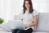 Relaxed woman with laptop on her knees