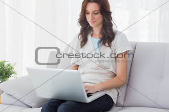 Relaxed woman with laptop on her knees