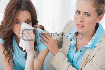 Therapist with her patient crying looking at camera