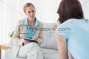 Young psychologist listening to her patient