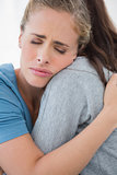 Woman taking her sad friend in her arms
