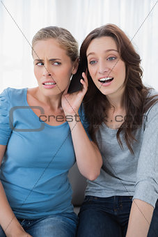 Disillusioned friends listening to mobile phone