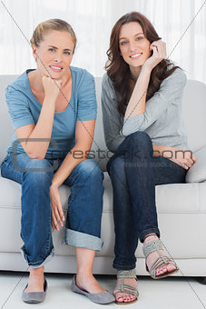 Relaxed women posing while sitting on the couch