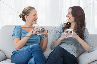 Friends having coffee and looking at each other