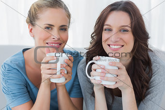 Friends having coffee and looking at camera