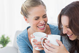 Friends bursting out laughing while having coffee