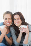 Cheerful women holding their cup of coffee