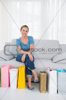 Cheerful blonde woman with shopping bags
