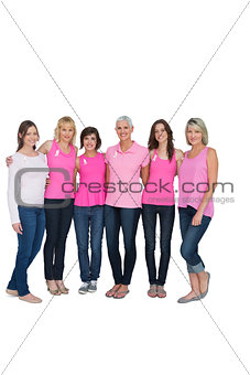 Smiling women posing with pink tops for breast cancer awareness