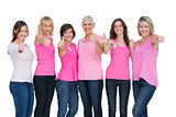Positive women wearing pink for breast cancer posing