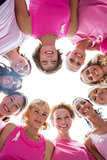 Group of women in circle wearing pink for breast cancer