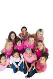 Cheerful pretty women looking up wearing pink for breast cancer