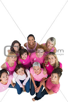 Cheerful pretty women looking up wearing pink for breast cancer