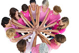 Cheerful women joined in a circle wearing pink for breast cancer