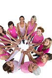 Happy women joined in a circle wearing pink for breast cancer