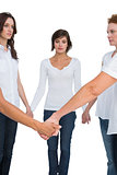 Pensive women standing and holding hands in a circle