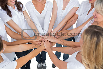 Female models joining hands in a circle