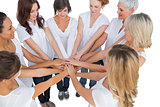 Peaceful female models joining hands in a circle