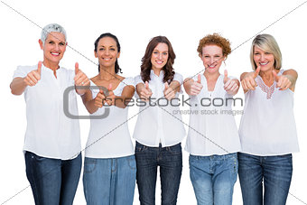 Cheerful casual models posing together with thumbs up