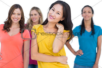 Natural models posing with elegant brunette on foreground touching her neck