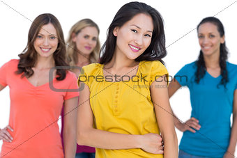Natural models posing with elegant brunette on foreground hands on hips