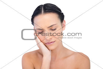 Young model posing while touching her cheek