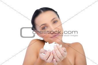 Smiling natural brunette holding tissue