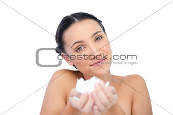 Happy natural brunette holding tissue