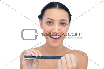 Surprised young model with nail file