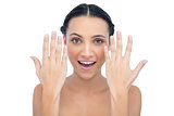Surprised natural model posing with hands up