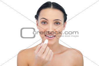 Smiling natural model using lip balm