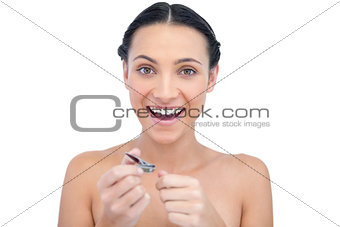 Enthusiastic natural model using nail clippers