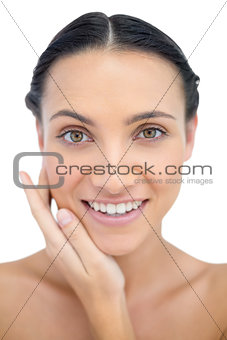 Smiling sensual model posing touching her cheek