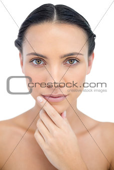Pensive sensual model posing while touching her chin