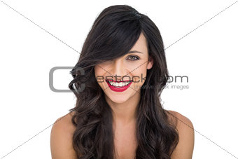 Cheerful dark haired woman posing