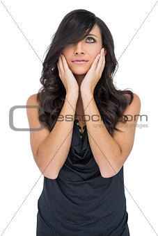 Anxious brown haired model posing holding her head