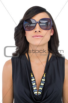 Serious elegant brunette wearing sunglasses