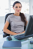 Serious businesswoman sitting on her swivel chair