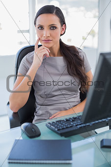 Thoughtful businesswoman sitting on her swivel chair